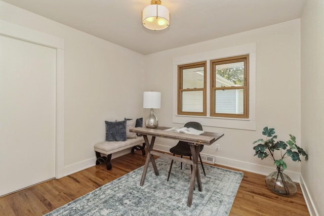 office space with wood finished floors and baseboards