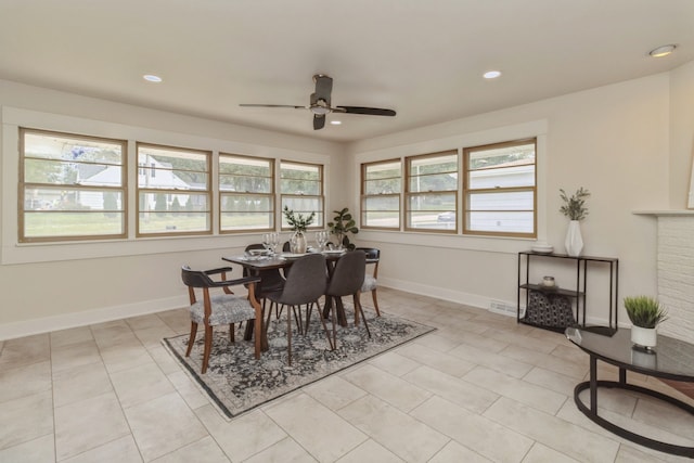 tiled dining room with ceiling fan and a healthy amount of sunlight