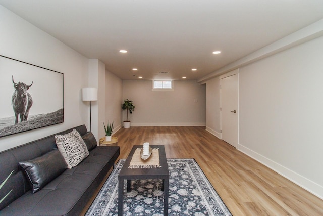 living room featuring baseboards, wood finished floors, and recessed lighting