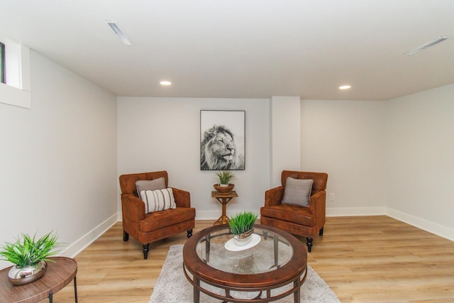 living area featuring baseboards, recessed lighting, visible vents, and light wood-type flooring