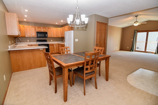 dining area with lofted ceiling, sink, light colored carpet, and ceiling fan with notable chandelier