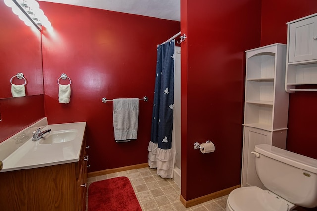 bathroom with vanity, curtained shower, and toilet