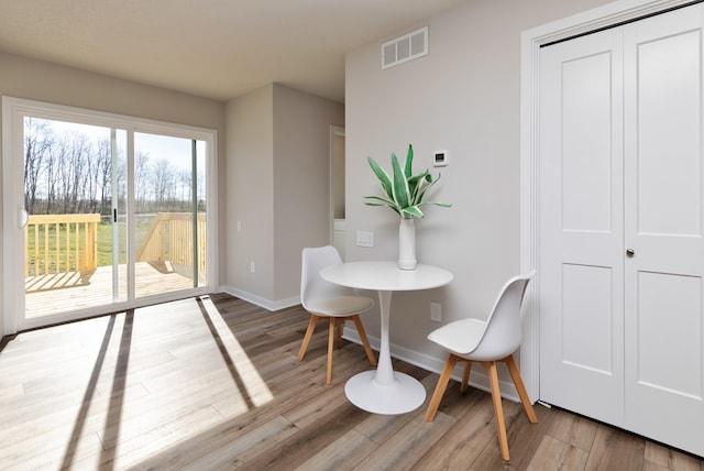 dining space with hardwood / wood-style flooring