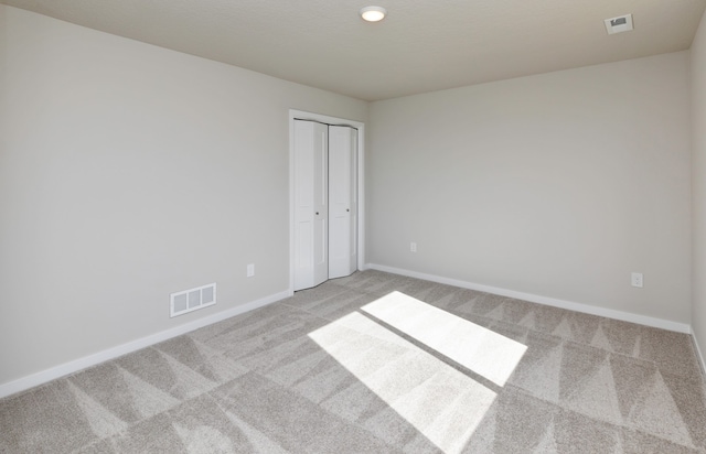 unfurnished room with light colored carpet