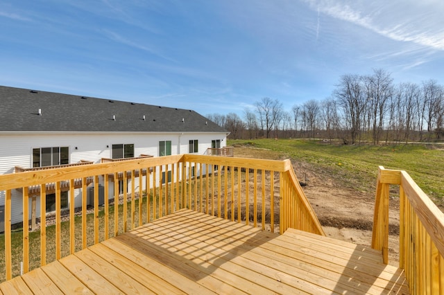 wooden terrace with a lawn