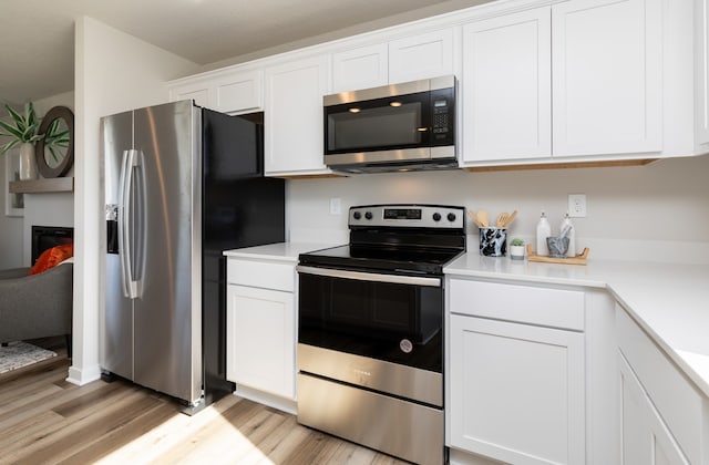 kitchen with stainless steel appliances and white cabinets