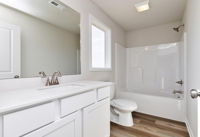 173 NE 56th St, Pleasant Hill, IA 50327 - full bath with toilet, wood finished floors, vanity, and tub / shower combination