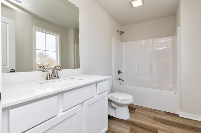 full bathroom with shower / washtub combination, wood-type flooring, vanity, and toilet