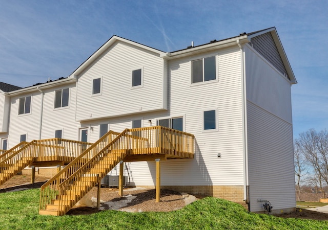 back of property with central AC and a wooden deck