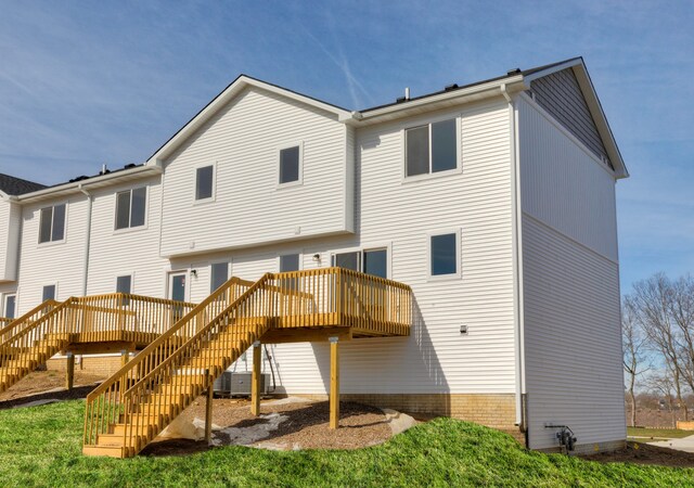 rear view of house with a deck and central air condition unit