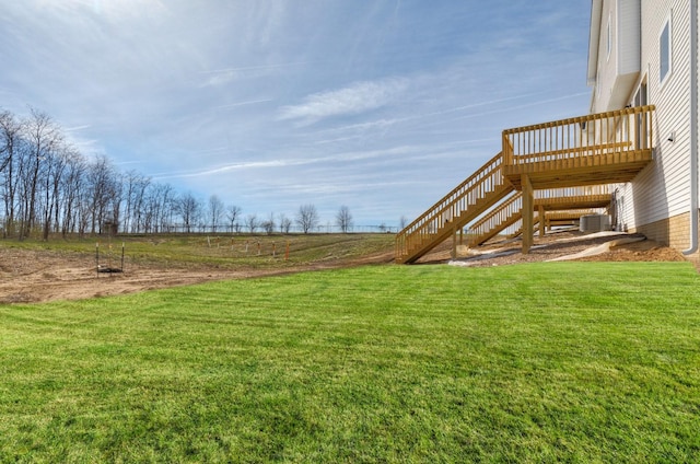 161 NE 56th St, Pleasant Hill, IA 50327 - view of grassy yard featuring stairway, central AC, and a wooden deck
