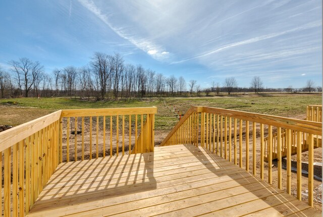 wooden terrace featuring a rural view