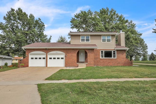 front of property featuring a front lawn and a garage