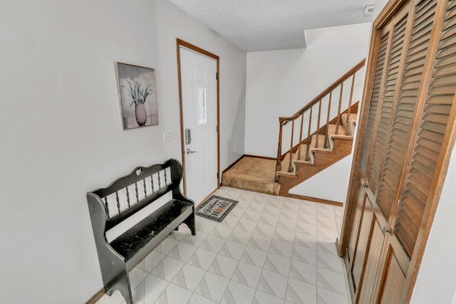 entryway with a textured ceiling