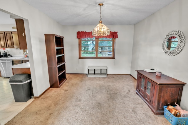 dining area with light colored carpet, a textured ceiling, and a chandelier