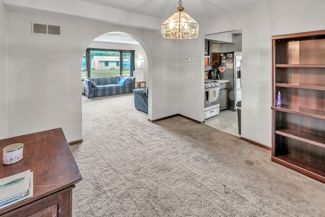 interior space with light colored carpet and a notable chandelier