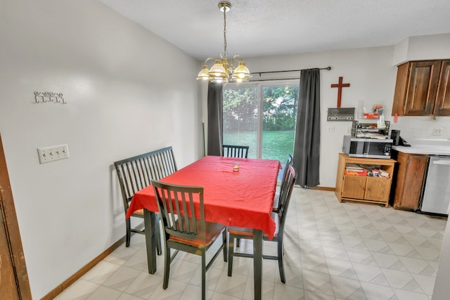 dining area with a chandelier and a textured ceiling