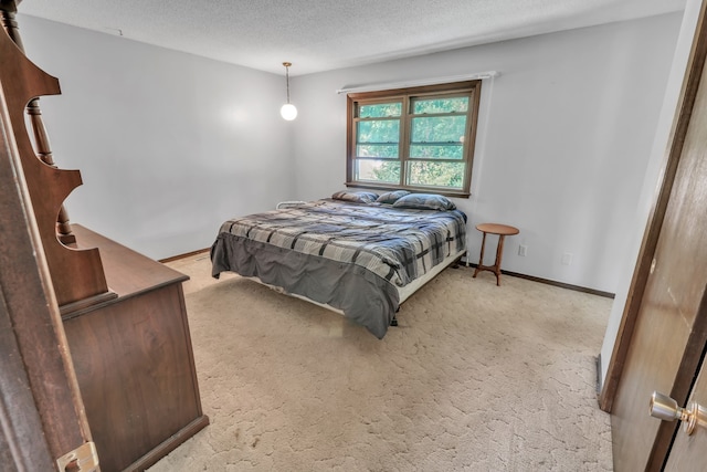 carpeted bedroom with a textured ceiling