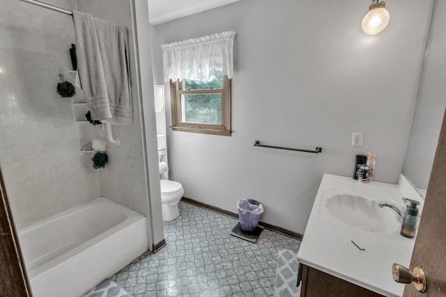 full bathroom featuring vanity, tiled shower / bath combo, and toilet