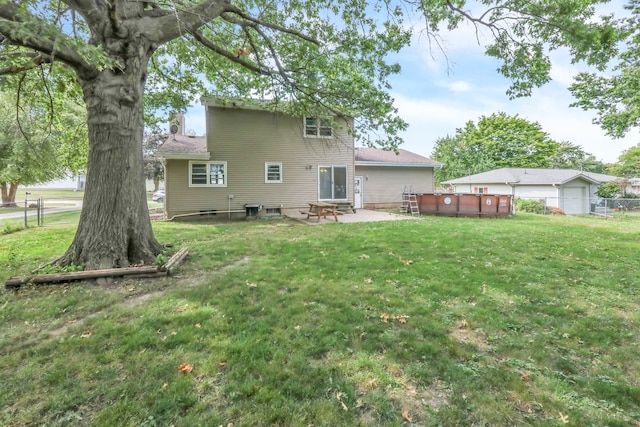 back of property with a lawn and a patio