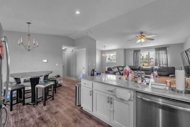 kitchen with lofted ceiling, white cabinetry, dishwasher, ceiling fan with notable chandelier, and hardwood / wood-style floors