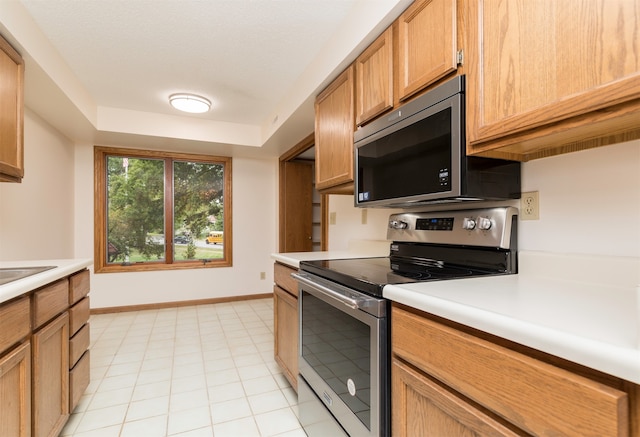 kitchen with appliances with stainless steel finishes and light tile patterned floors