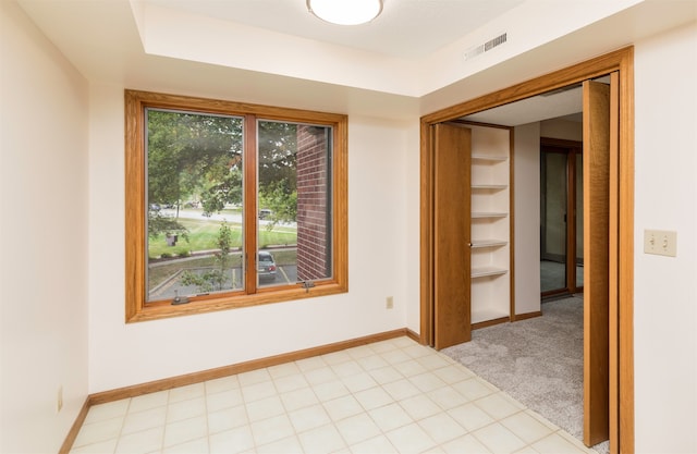 empty room featuring light colored carpet