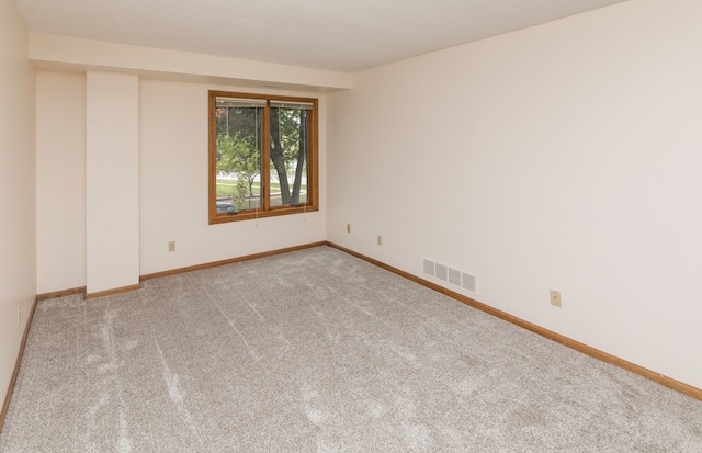 unfurnished room featuring carpet