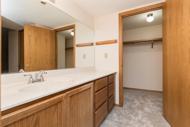 bathroom with a textured ceiling and vanity