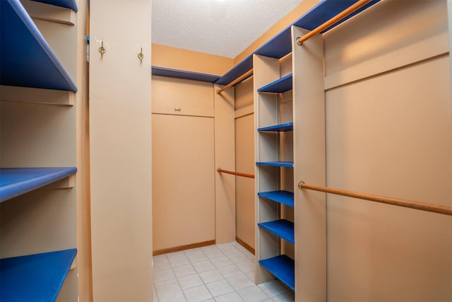 spacious closet with light tile patterned floors