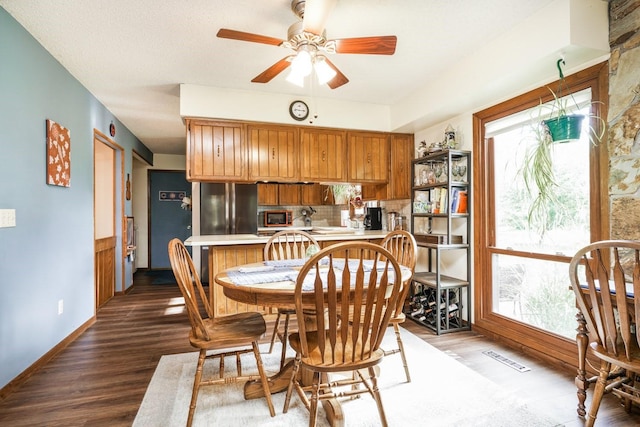 dining room with ceiling fan and wood-type flooring