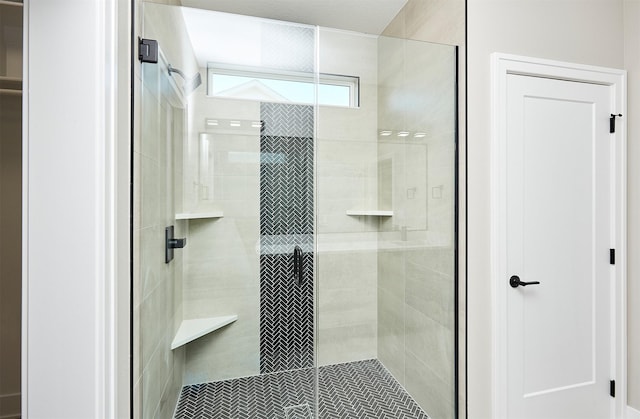 bathroom with a shower with shower door