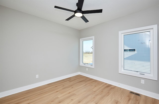 spare room with light hardwood / wood-style floors and ceiling fan