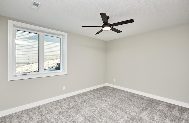 carpeted empty room featuring a textured ceiling and ceiling fan