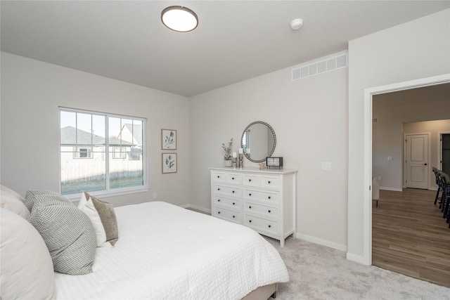 bedroom featuring light colored carpet