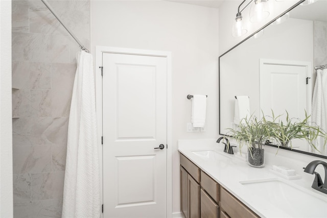 bathroom with curtained shower and vanity