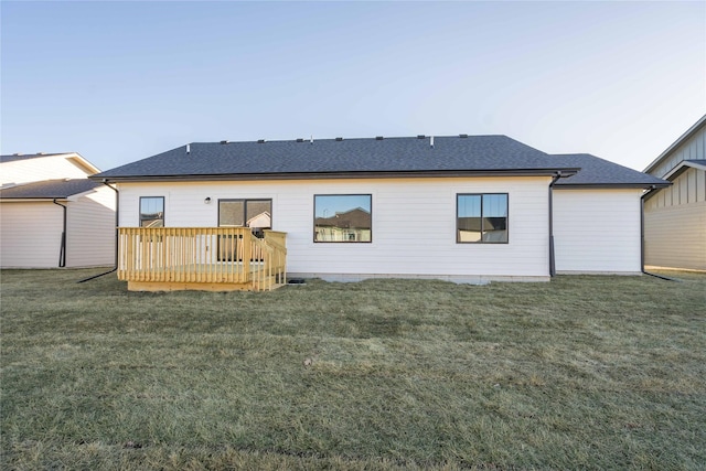 back of property featuring a yard and a deck