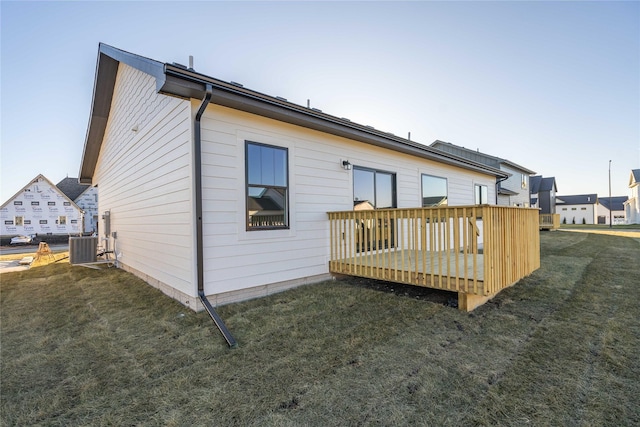 back of house featuring a yard and a wooden deck