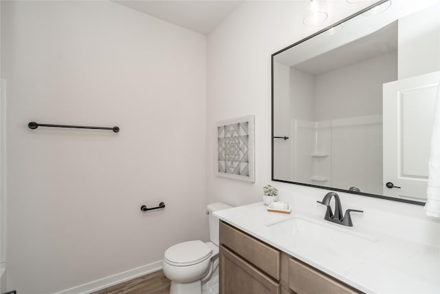 bathroom featuring hardwood / wood-style floors, vanity, and toilet