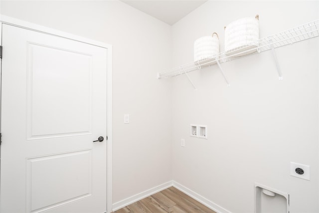 laundry area featuring hookup for an electric dryer, washer hookup, and light hardwood / wood-style flooring