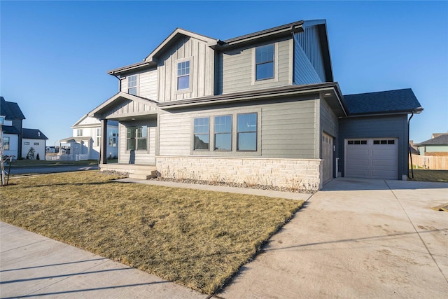 view of front of house with a front yard and a garage