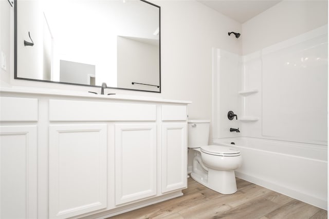 full bathroom featuring vanity, toilet, wood-type flooring, and bathing tub / shower combination