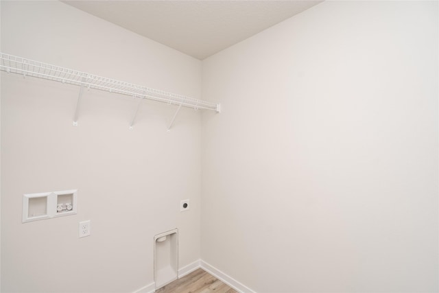 clothes washing area featuring hookup for an electric dryer, hookup for a washing machine, and light hardwood / wood-style floors