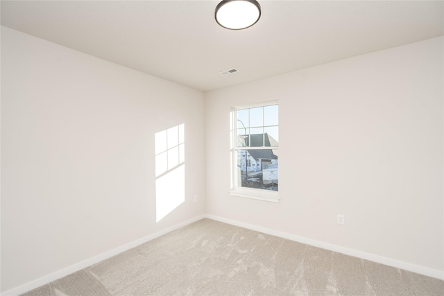 unfurnished room with light carpet