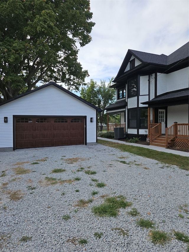 view of side of home featuring central AC, a garage, and an outdoor structure