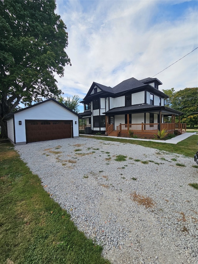 view of front facade with a porch, an outdoor structure, and a garage