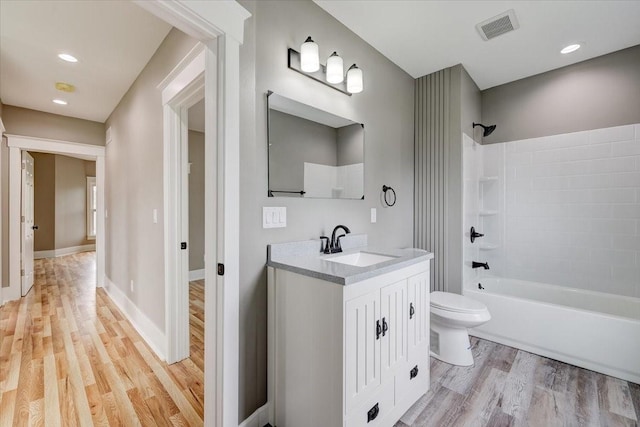 full bathroom with toilet, vanity, shower / bath combination, and hardwood / wood-style flooring