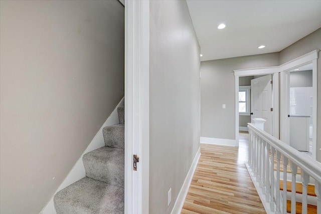 stairway with hardwood / wood-style floors