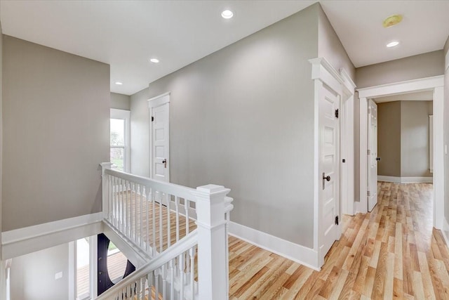 hallway with light hardwood / wood-style floors