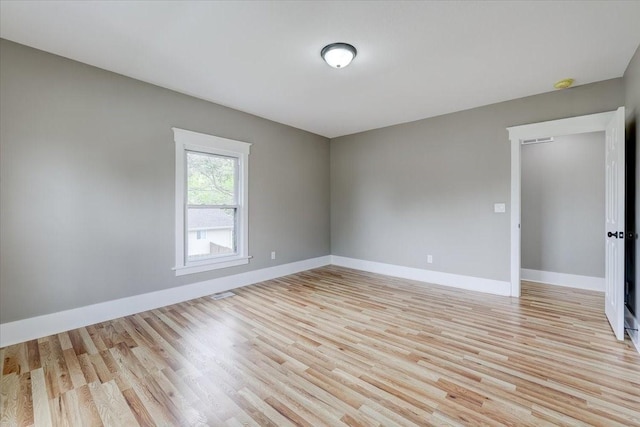 empty room with light hardwood / wood-style floors